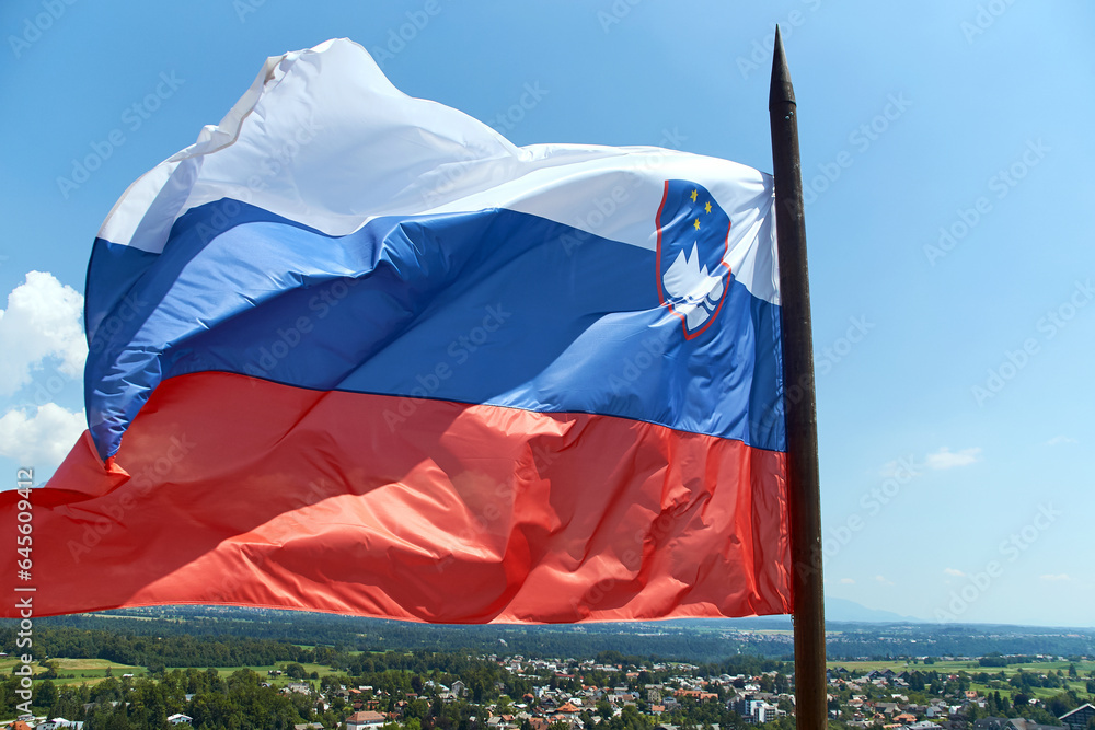 Waving National flag of Slovenia on the blue sky background
