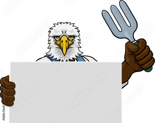 A gardener, farmer or handyman eagle cartoon mascot man holding a gardening tool