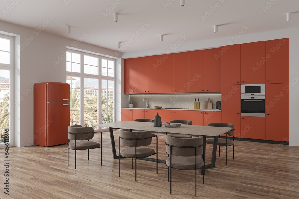 Orange home kitchen interior with dining and cooking space, panoramic window