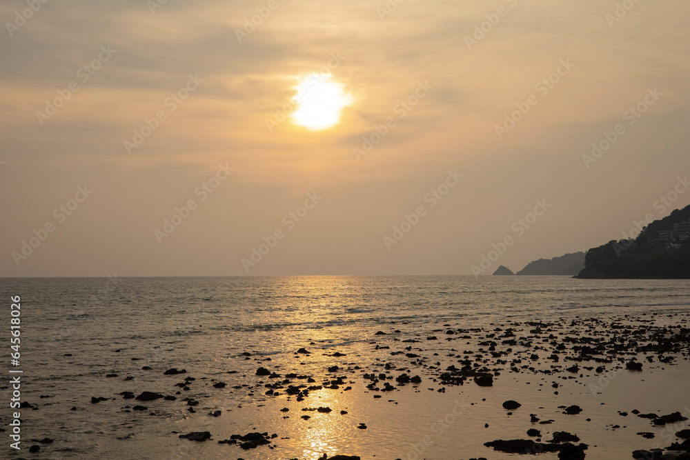 Coastal sunset, orange sky, evening silhouette, calm calm sea shore with light ocean waves, sunlight shining, natural beautiful reflections. summer sky Suitable for recreation, vacation, family fun