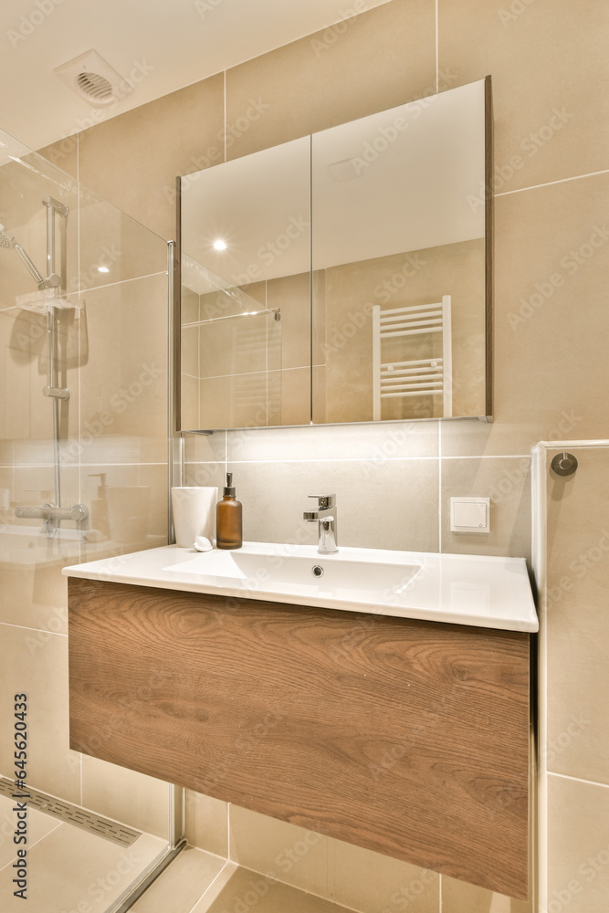 a bathroom with a sink, mirror and shower stall in the corner on the left is a white toilet next to the right is a bathroom with a sink, mirror and shower stall in the corner on the left is a white toilet next to the right is