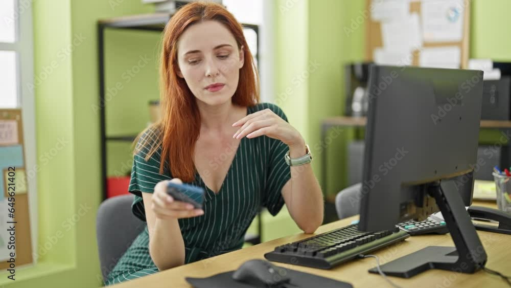 Young redhead woman business worker stressed using smartphone at office Young redhead woman business worker stressed using smartphone at office