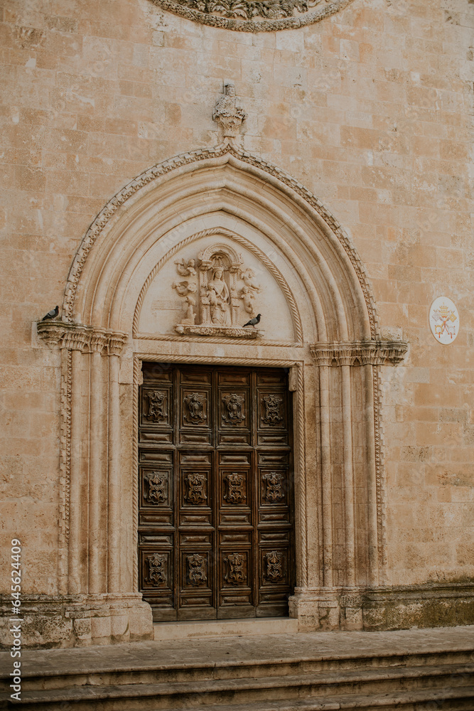 Door at church San Francesco d’Assisi in Ostuni, Italy