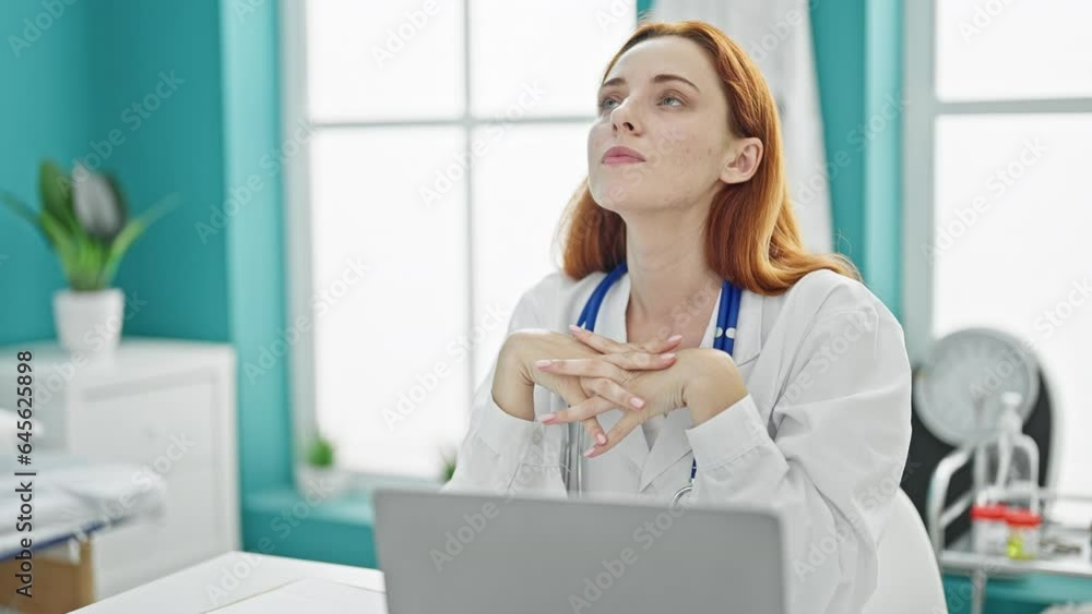 Young redhead woman doctor stressed working at clinic Young redhead woman doctor stressed working at clinic