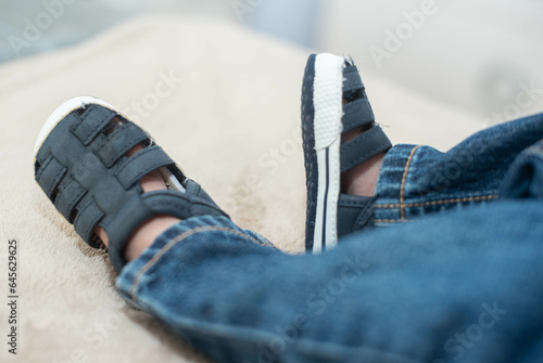 baby shoes on a bed