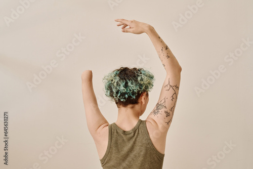 Rear view of young girl with amputee arm posing against white background photo