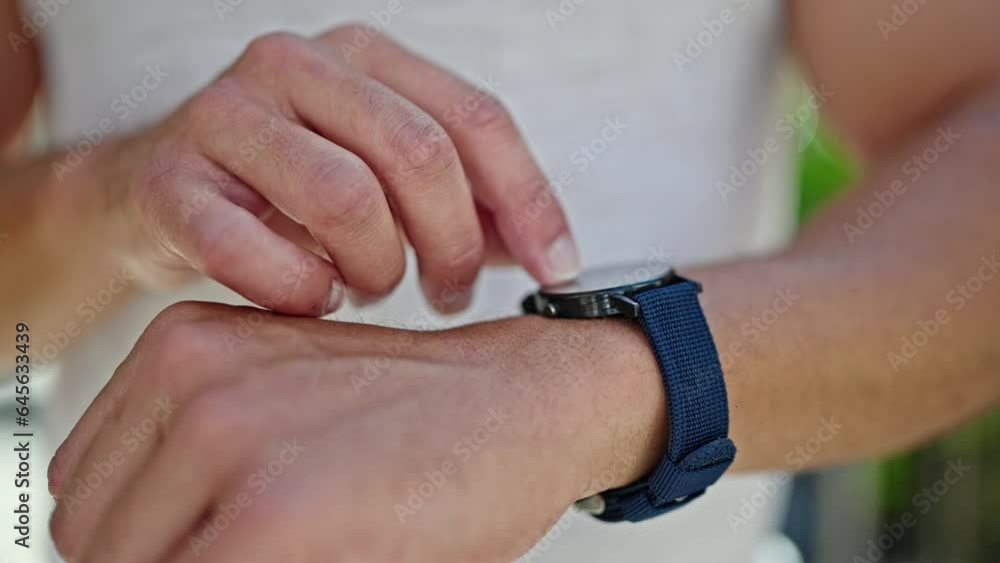 Young hispanic man pointing watch at street Young hispanic man pointing watch at street