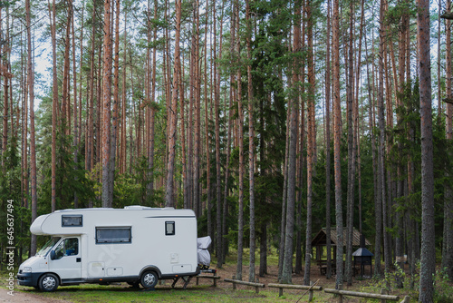 Nature camping on Lake Peipus in autumn.  Car, mobile home in a pine forest.