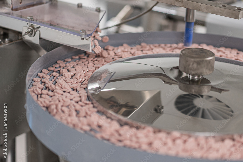 Macro Shot of colour Pills and Capsules During Production and Packing Process on Modern Pharmaceutical Factory. Tablet and Capsule Manufacturing Process. Close-up Shot of Medical Drug Production Line.