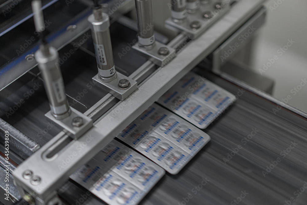 Macro Shot of colour Pills and Capsules During Production and Packing Process on Modern Pharmaceutical Factory. Tablet and Capsule Manufacturing Process. Close-up Shot of Medical Drug Production Line.