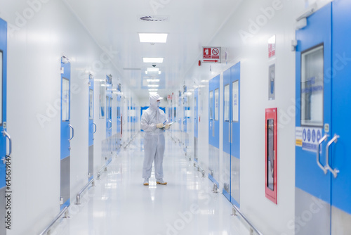 Focus chemistry man with biochemistry suit at the Walkway in the spacious and bright laboratory workplace for doctor and scientist in Pharma business factory.