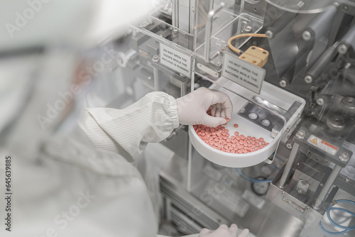 Macro Shot of colour Pills and Capsules During Production and Packing Process on Modern Pharmaceutical Factory. Tablet and Capsule Manufacturing Process. Close-up Shot of Medical Drug Production Line.