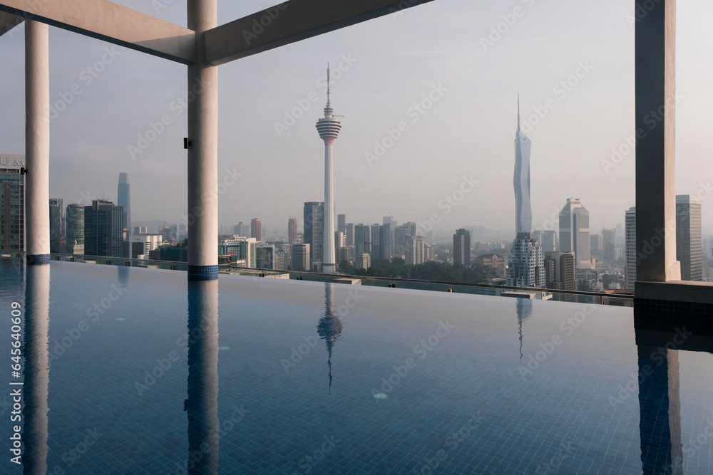 Fototapeta premium View of rooftop swimming pool and the city with Kuala Lumpur and Merdeka 118 Towers on sunny day. Malaysia.