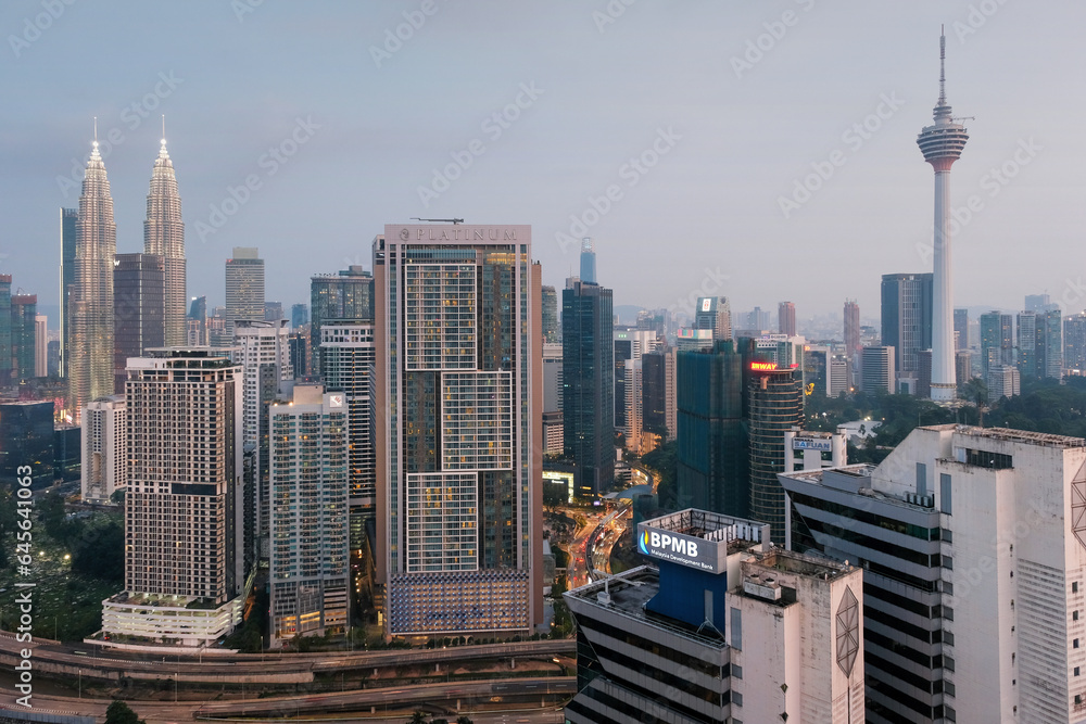 View of the city, Petronas Twin Towers and Kuala Lumpur Tower in the evening. Kuala Lumpur, Malaysia.