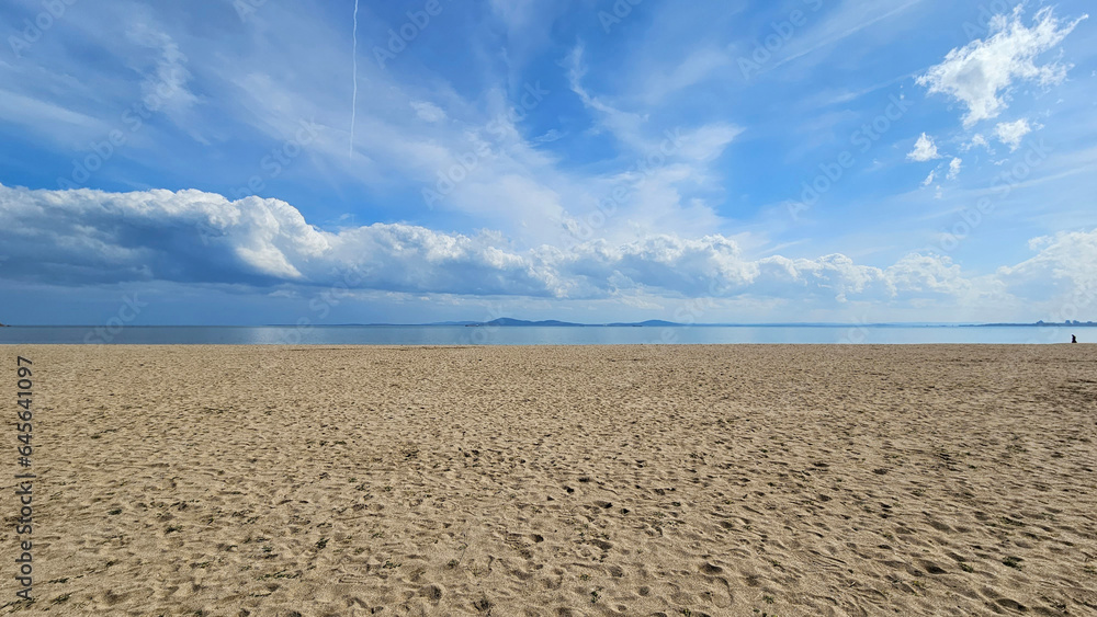 Sea landscape with sandy beach and beautiful sky with white clouds Sea landscape with sandy beach and beautiful sky with white clouds