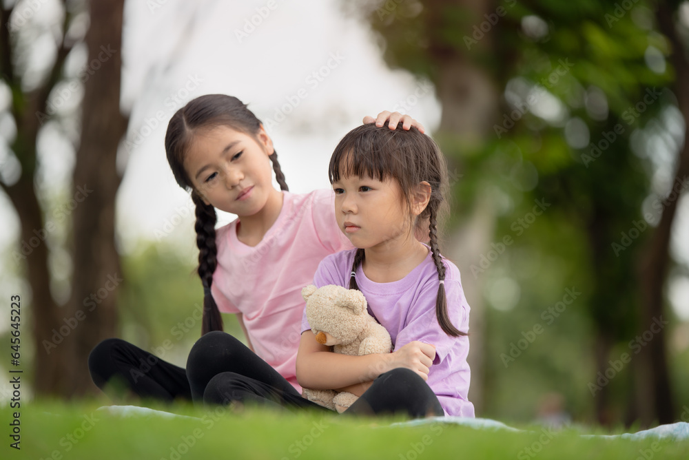 Asian family children elder sister comforts her younger sister Asian family children elder sister comforts her younger sister