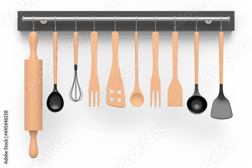 Set of kitchen utensil for preparation of dough hanging on shelf on white.