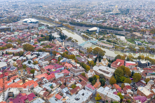Aerial view of Old Town and Bridge Of Peace over Kura river on cloudy day. Tbilisi, Georgia.