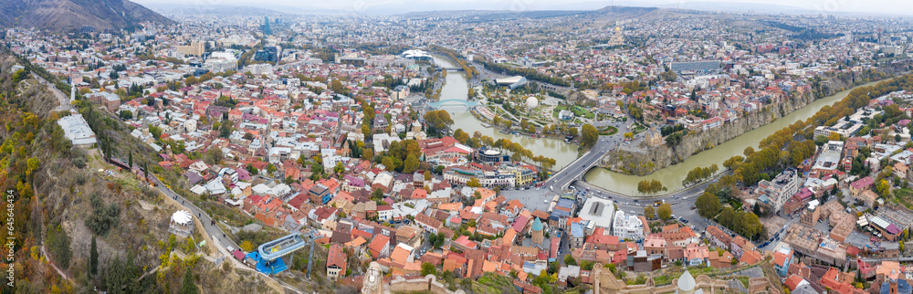 Panoramic aerial view of Tbilisi and Kura river on cloudy autumn day. Georgia.