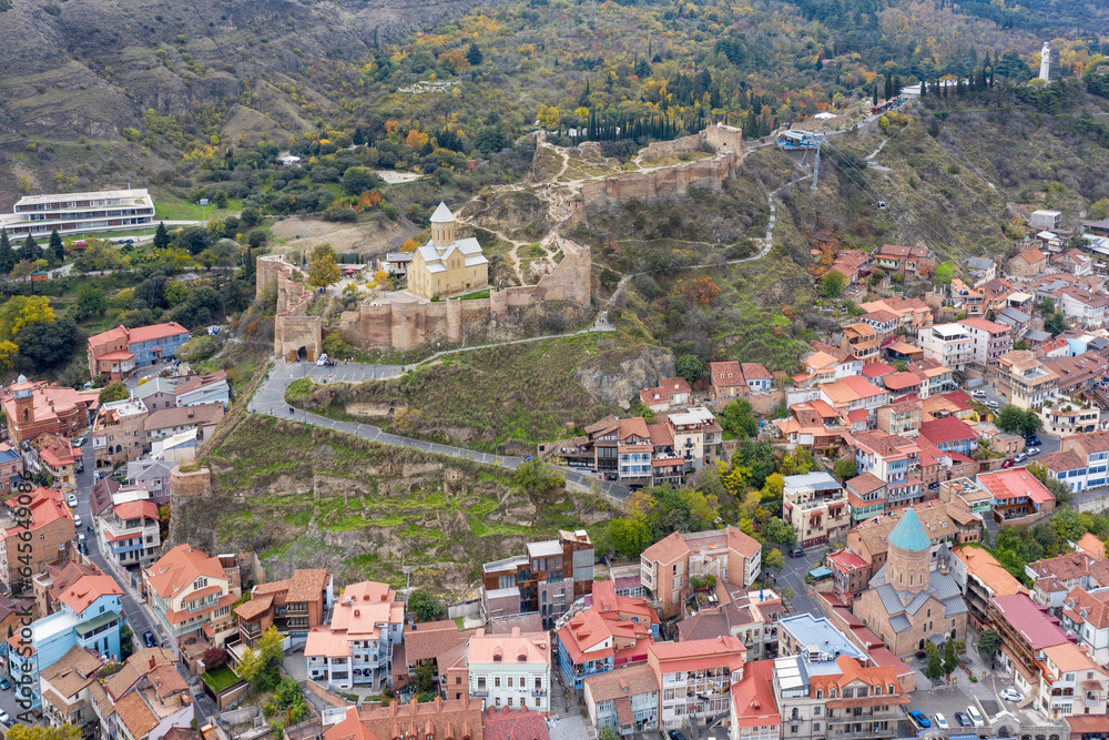 Aerial view of Old Town, Narikala Fortress, Saint Nicholas's Church and St. George Cathedral  on cloudy day. Tbilisi, Georgia.
