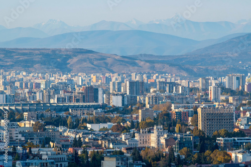 Tbilisi on the background of Caucasus Mountain Range on sunny autumn day. Georgia.