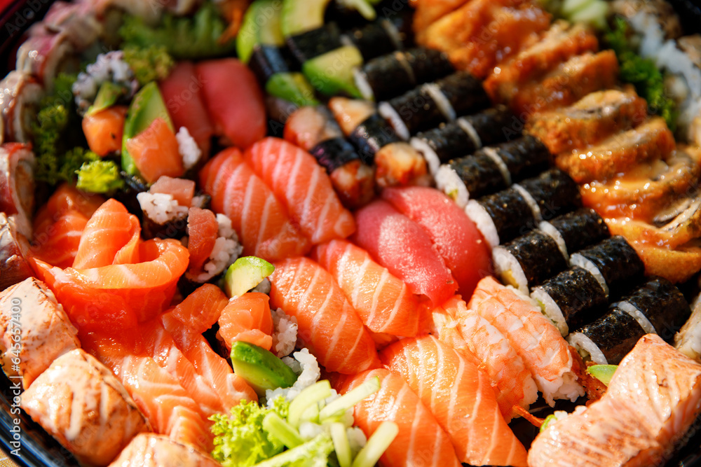 Assorted Sushi Nigiri and Maki Big Set on Slate. A Variety of Japanese Sushi with Tuna, Crab, Salmon, Eel, and Rolls. Top View. Assorted Sushi Nigiri and Maki Big Set on Slate. A Variety of Japanese Sushi with Tuna, Crab, Salmon, Eel, and Rolls. Top View.