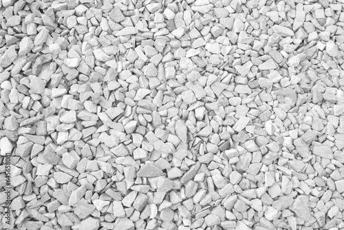 Gray white small rocks ground texture. pebbles stone texture. background of crushed granite gravel, close up. clumping clay