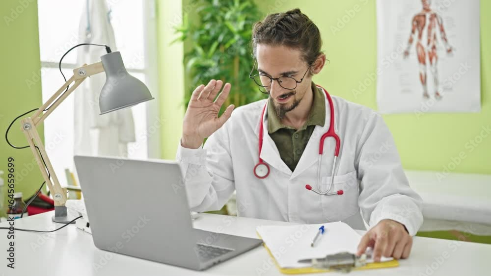 Young hispanic man doctor finishing video call stressed at clinic Young hispanic man doctor finishing video call stressed at clinic
