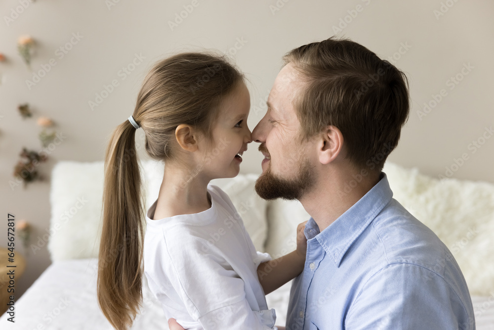 Happy dad cuddling cute little daughter kid with affection, tenderness, kissing beloved girl with noses touch, smiling, laughing, having fun, enjoying fatherhood relationship, family leisure Happy dad cuddling cute little daughter kid with affection, tenderness, kissing beloved girl with noses touch, smiling, laughing, having fun, enjoying fatherhood relationship, family leisure