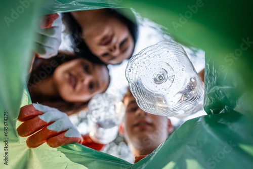 POV from inside of bag young volunteer teenagers collect plastic waste