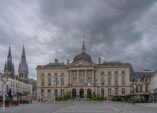 Chalons-en-Champagne, France - 09 01 2023: View of the facade of the City Hall with the bell towers of the Notre-Dame-en-Vaux Collegiate Church in background. photo