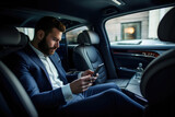 Businessman Using Smartphone in Chauffeured Car