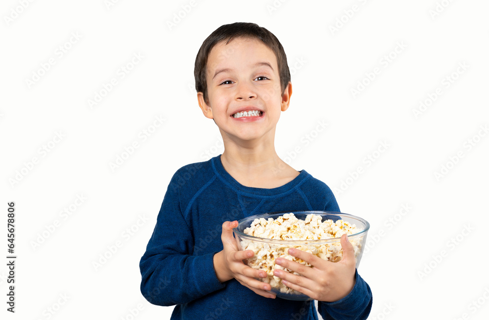 Dark haired little child eating popcorn snack isolated white background with a happy face standing and smiling with a confident smile showing teeth Dark haired little child eating popcorn snack isolated white background with a happy face standing and smiling with a confident smile showing teeth