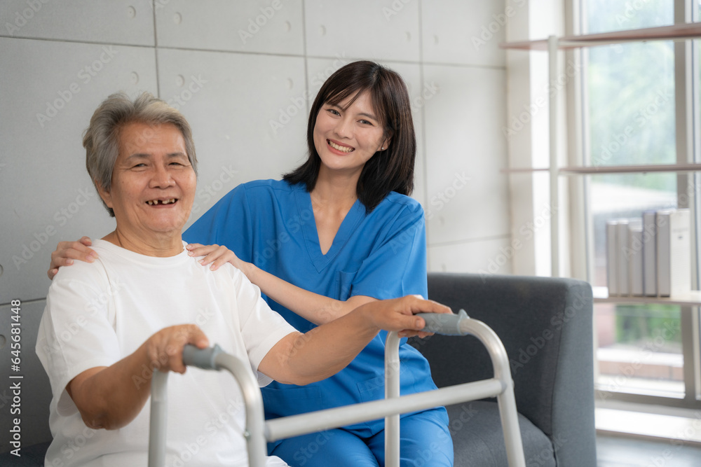 Portrait of nurse and patient looking to camera and smile at hospital. Nurse taking care of senior woman to physical therapy at hospital.