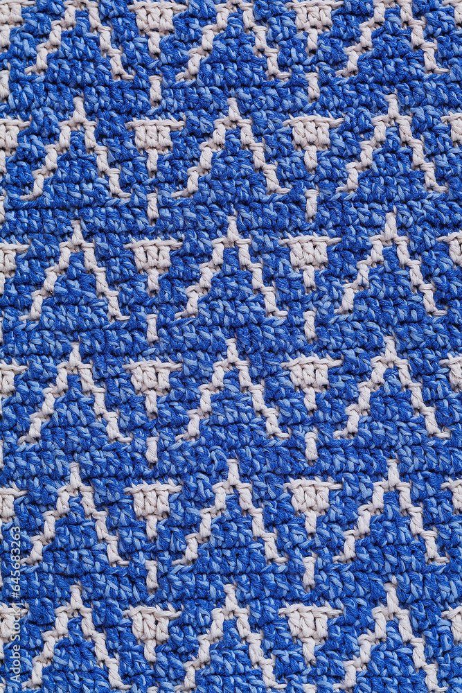White blue crochet texture with abstract mosaic pattern. Knitted background.