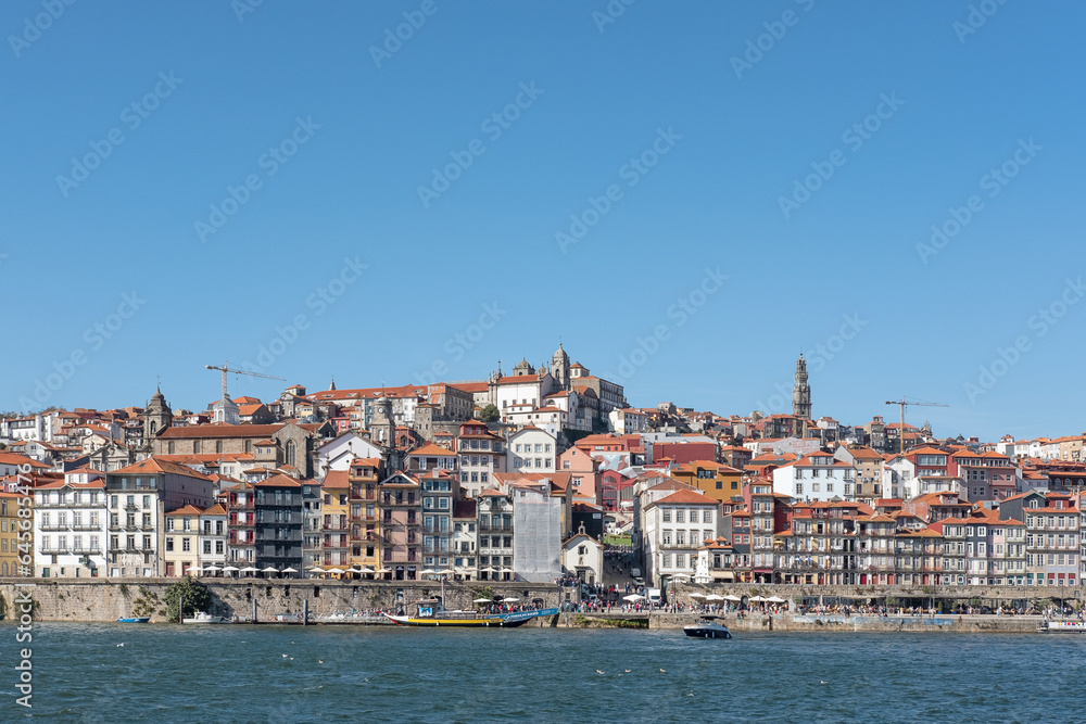 Views from Douro River towards the northern bank featuring the distinctive and authentic local architecture of the waterfront neighborhood, the Ribeira district in Porto, Portugal