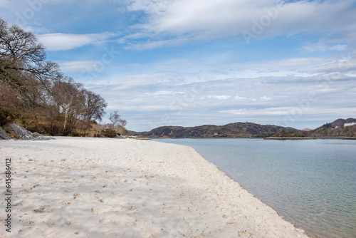 Silver sands of Morar, unusual beaches with white sand and shallow waters lining the tranquil southern bank of River Morar, beautiful Scottish scenery near the popular town of Mallaig, Scotland, UK © Ana