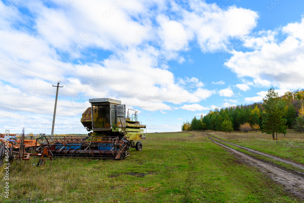 Fototapeta premium Abandoned combine harvester. Rusty spoiled combine harvester.