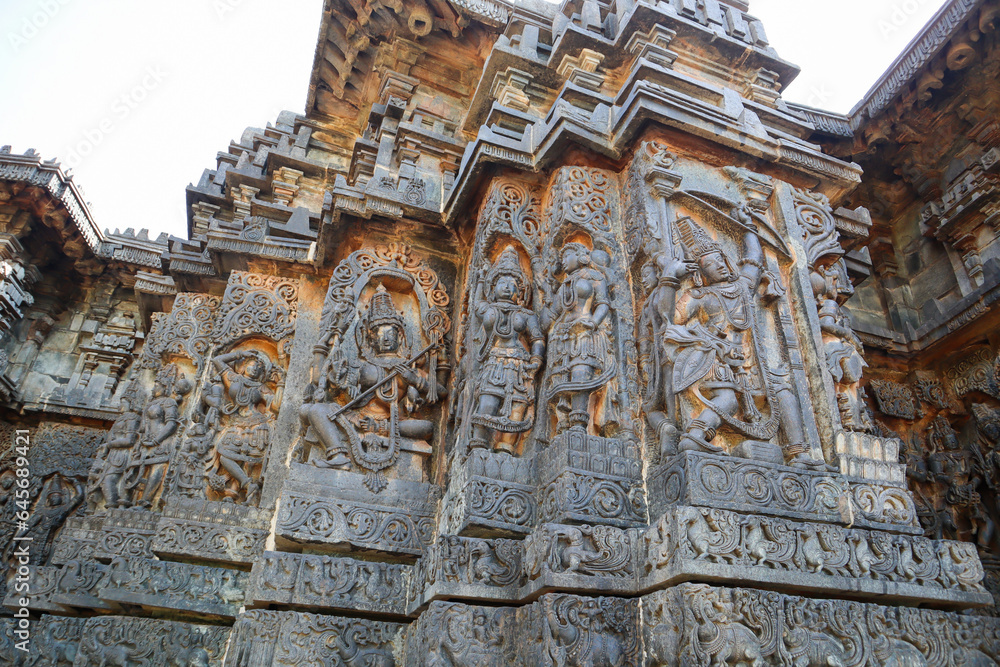 A Eye catching Sculpture carvings of Hindu Gods, Goddesses and Dancers on the exterior walls of Hoysaleshwara temple at Halebeedu in Karnataka, India.