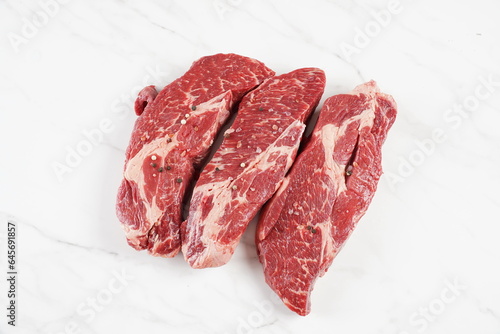Plain fresh cut chuck steak prepared for cooking photo