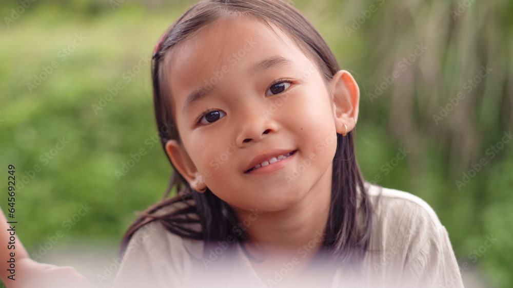 Beautiful child looking at camera with nature background. Beautiful child looking at camera with nature background.
