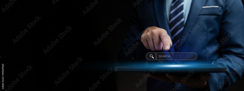 Person with search box hologram, businessman type a search term into the search box on the internet to find the information he is looking for. Information search concept.