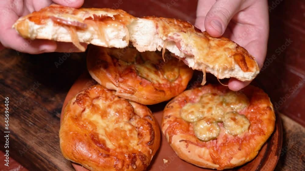 the finished mini pizza is torn in half the finished mini pizza is torn in half