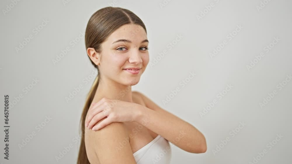 Young beautiful girl smiling confident touching arm over isolated white background