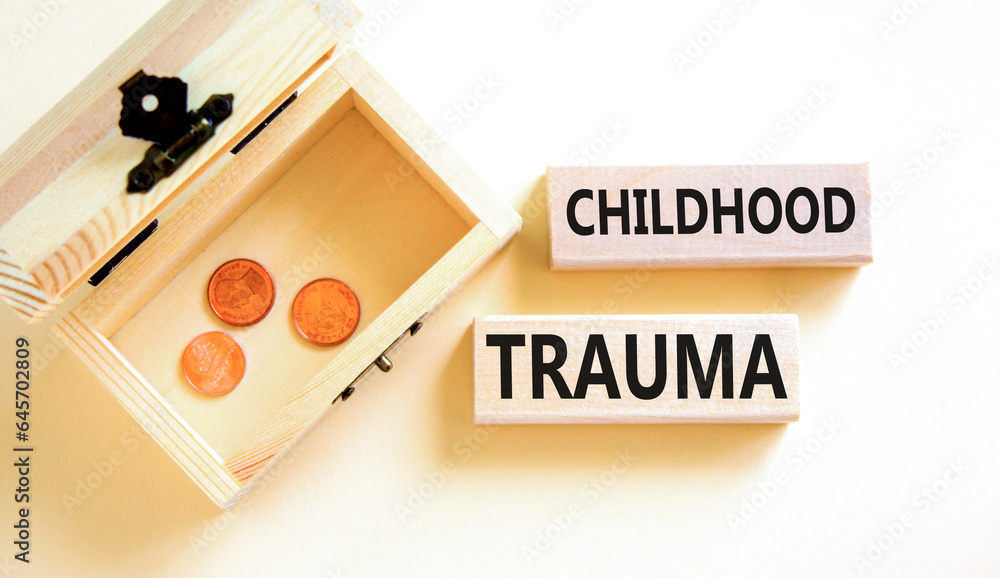 Childhood trauma symbol. Concept words Childhood trauma on beautiful wooden blocks. Beautiful white table background. Wooden chest with coins. Business psychology childhood trauma concept. Copy space. Childhood trauma symbol. Concept words Childhood trauma on beautiful wooden blocks. Beautiful white table background. Wooden chest with coins. Business psychology childhood trauma concept. Copy space.