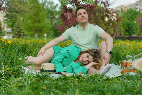 couple on romantic date, sitting on picnic blanket in blossoming park. close-up captures concept of dating, romance, creativity, mindfulness, respect, budding feelings of love and attachment. photo