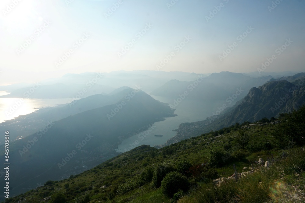 Beautiful panoramic view from the top of the mountain to the Bay of Kotor in the early morning. Sunrise and heavy fog.