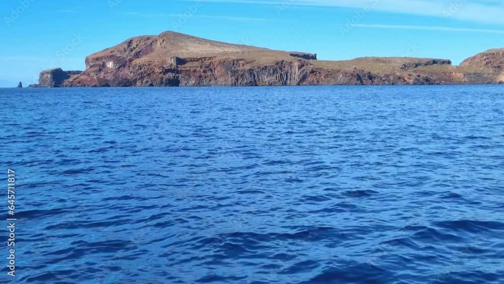 View of uninhabited islands in the Atlantic Ocean from a boat View of uninhabited islands in the Atlantic Ocean from a boat
