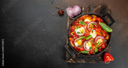 Frying pan with fresh shakshuka, Middle eastern traditional dish, Long banner format. top view photo