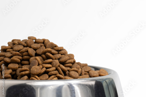 Close up of Cat food in bowl isolate on white background with clipping path. Front view of Pet pellet food in stainless steel bowl.